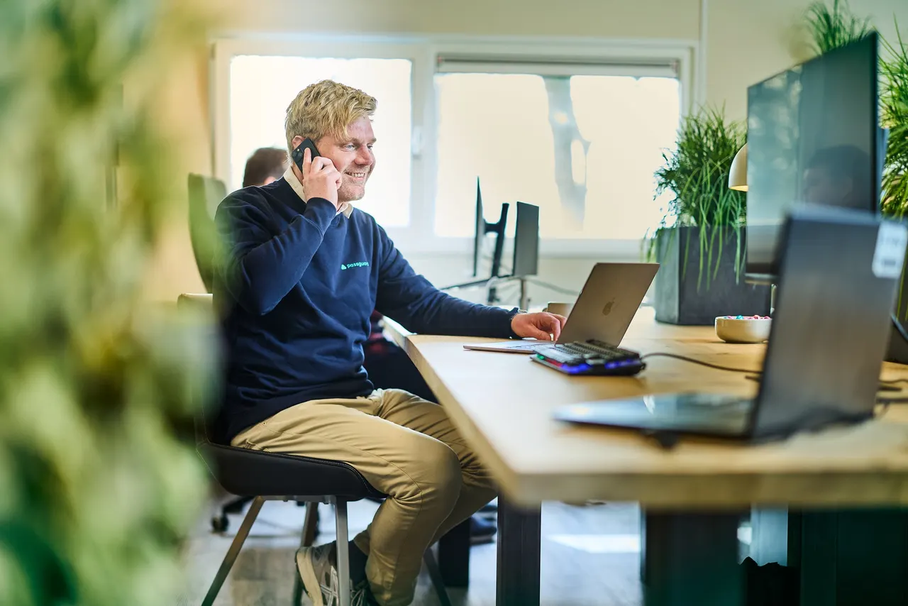 A colleague on the phone at his desk